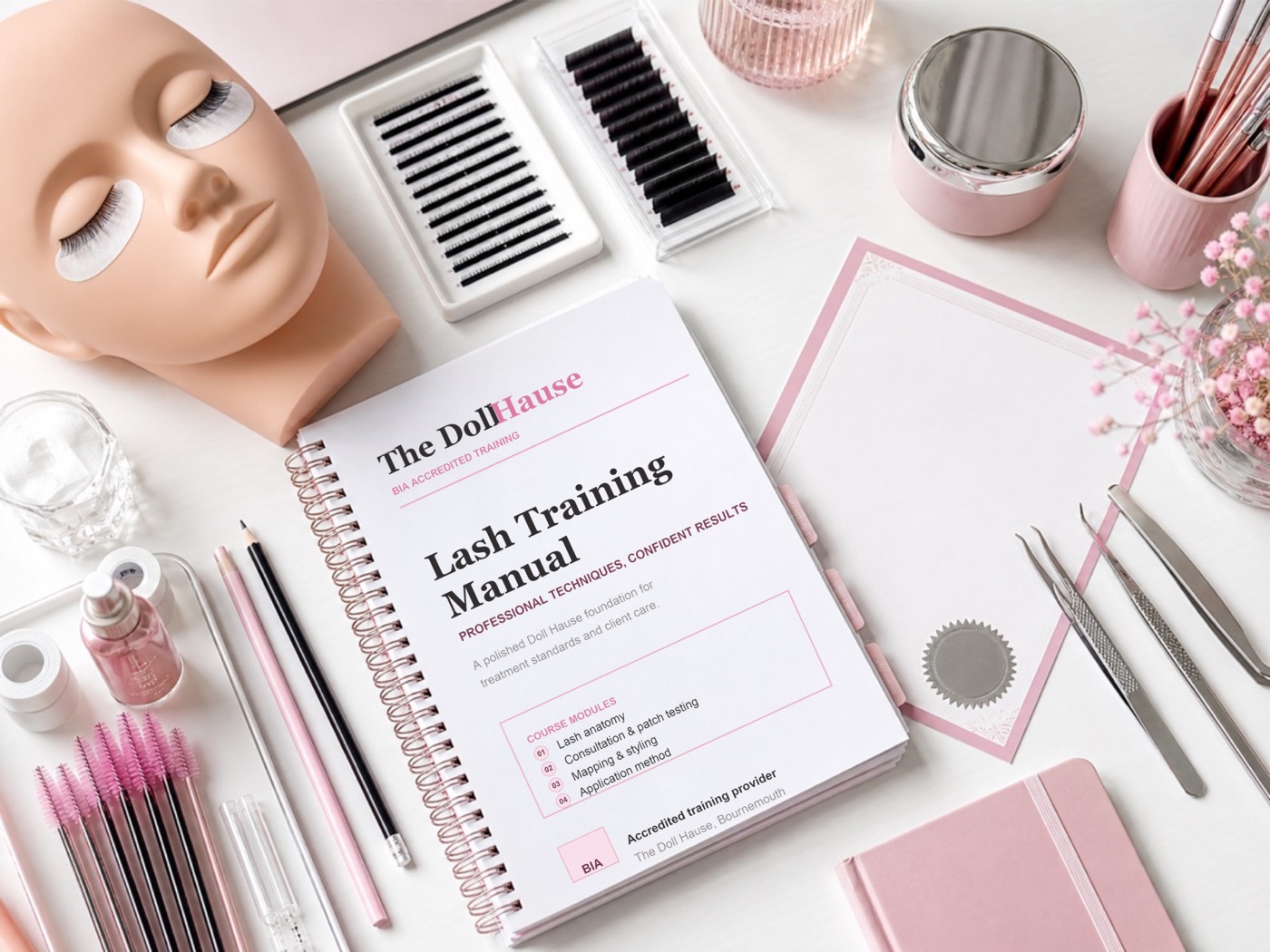 Branded Doll Hause lash training manual with lash tools, practice materials and pink salon stationery